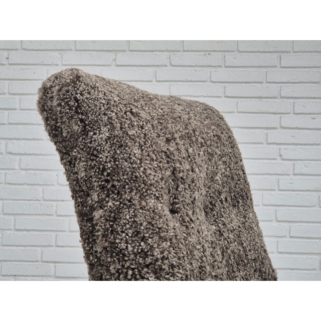 1960s, completely refurbished-reupholstered Danish armchair. Upholstered in quality genuine New Zealand sheepskin...