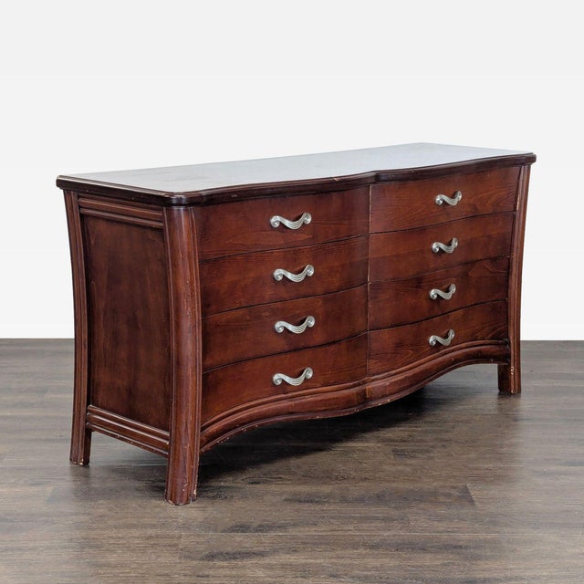 This classic wooden dresser features a unique curved front design and eight spacious drawers, perfect for organizing...