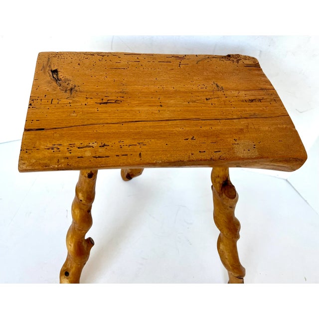 Imported from France. Handcrafted brutalist style fruit wood stool. The seat boasts a split log nestled on three twisted...