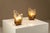A quiet interplay of light and glass defines this pair, where form is guided by material rather than excess. These lamps...