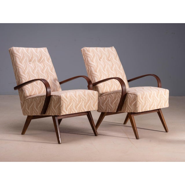 A pair of bentwood lounge armchairs designed by Jaroslav Šmídek, produced in Czechoslovakia. The chairs feature sculptural...