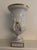 This Vintage Sandizell Hoffner White & Gold Large Urn with Cherubs is a decorative collectible piece that exudes elegance...