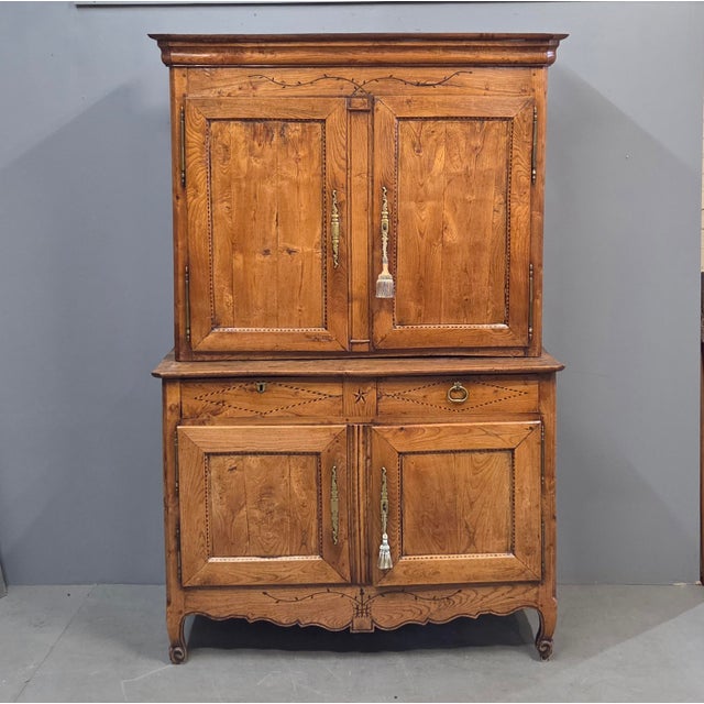 A gorgeous and functional antique late 1700s or early 1800s French elm buffet deux corps (two piece) cabinet. The old wood...