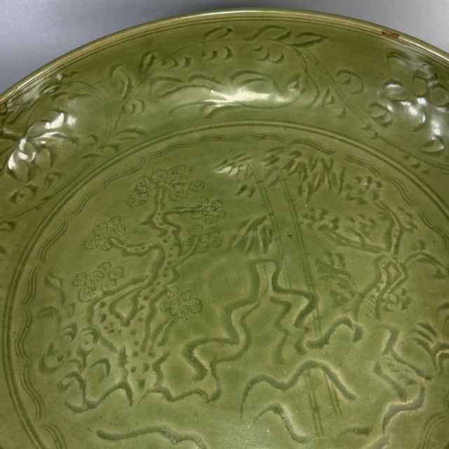 Striking Chinese celadon large plate, finely carved decorative motif across the interior surface, matching carved patterns...