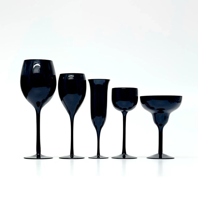 Black stemmed decorative glasses, group of 11. A glamorous curated decorative group of black stemmed glasses from the mid...