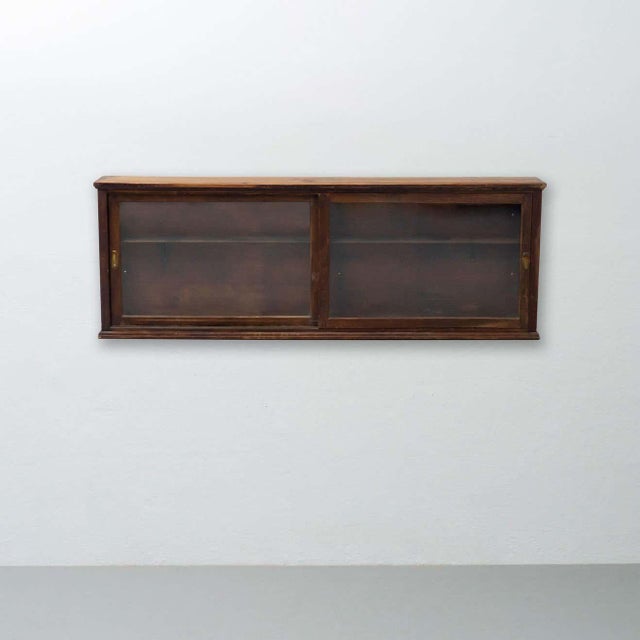 Vintage glass and wood showcase. By unknown manufacturer from France, circa 1950. In original condition, with minor wear...