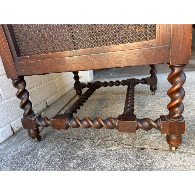 Antique Oak Bergere Armchair Featuring Barley Twist Legs, Arms, and Stretchers, With Cane Paneling Sides and Caster Wheels For Sale - Image 4 of 11