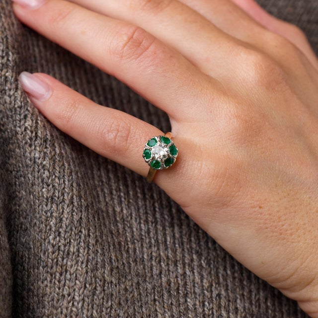 This elegant Edwardian cluster ring is a beautifully refined jewel from the 1910’s, centered by an old European cut...