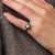 This elegant Edwardian cluster ring is a beautifully refined jewel from the 1910’s, centered by an old European cut...