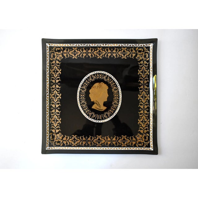 A vintage, mid-century large glass serving tray, black, with gold foliate details, central medallion, and Neoclassical...