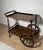 Elegant Spanish bar cart crafted in solid wood, featuring a classic two-tier design with finely turned legs and decorative...