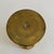 An antique, solid brass French trench art artillery shell/vase from World War I. This piece has a curved, bulbous shape...