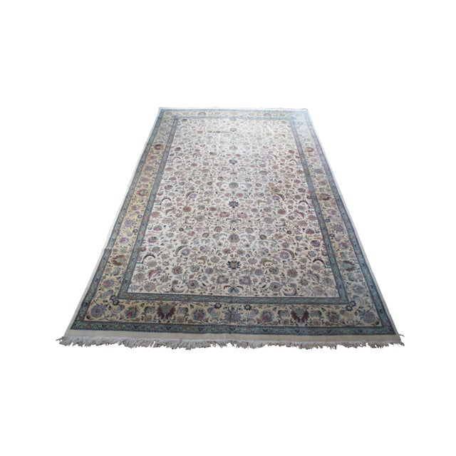 A large and impressive 100% wool pile area rug featuring a floral scene with animals (Deer, Birds) on a beige field with...