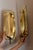 Made in Sweden. Two exquisite brass candle sconces from the Mid Century era, meticulously handcrafted with a stunning...