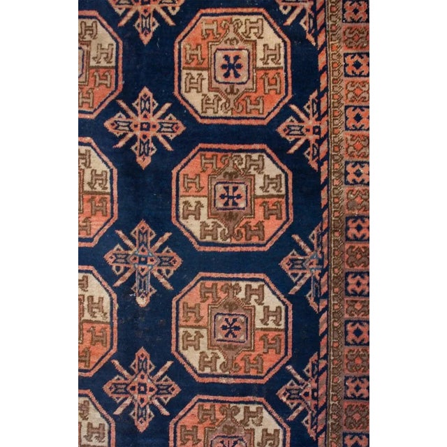 An early 20th century Central Asian Samarkand rug with fourteen octagonal medallions on an indigo background, surrounded...