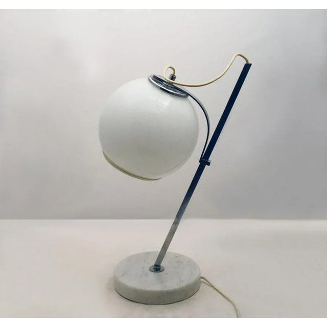 - Table lamp with marble base and lampshade in opaline glass - With latch system to adjust the lampshade height along the...