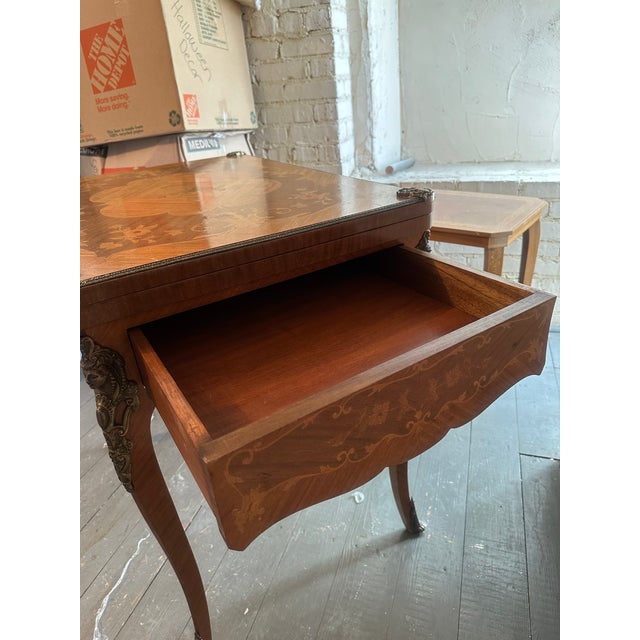 1930s French style game table - has 1 drawer and the top flips open to double the size. Has highly decorative brass female...