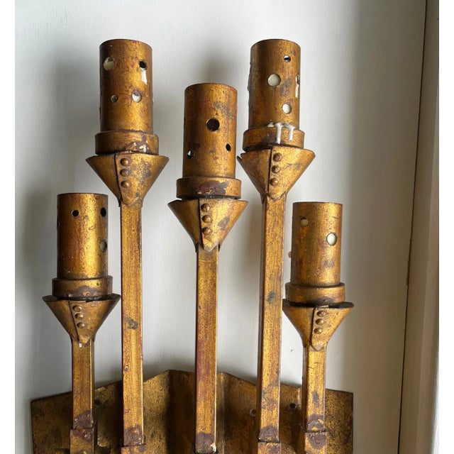 A brutalist wrought iron Spanish wall sconce. Circa 1950s, appears to be hand forged with a medieval design. Five candle...
