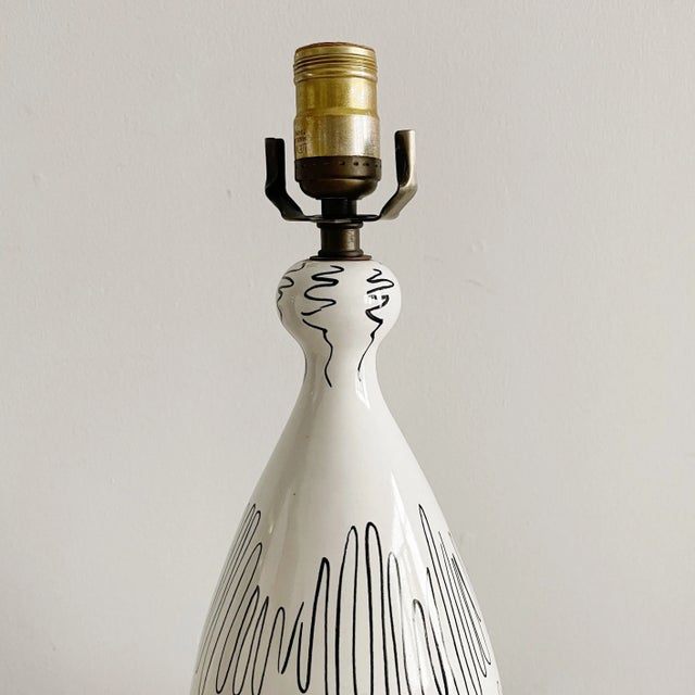 Rare ceramic table lamp by Raymor of Italy., with abstract black decoration over white hlaze. Signed Raymor Italy....