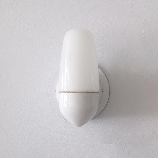 Wonderful porcelain wall lights by Wilhelm Wagenfeld for Lindner, 1950, in ivory porcelain with opaline glass bulb covers,...