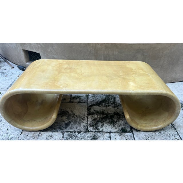Lacquered goatskin coffee table made around the 1970's in a curved waterfall design on each end. The table is not marked.