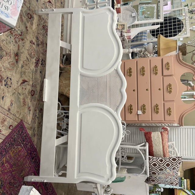 Vintage solid wood king size headboard with center cane insert. The graceful curved lines coupled with the cane insert...