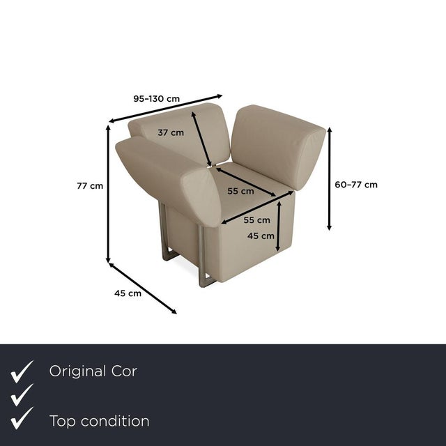 The Clou armchair by Cor is upholstered in cream-colored genuine leather and features a distinctive, cubic design. The...