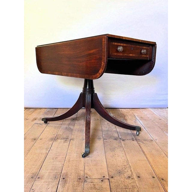 A fine early 19th century English Regency mahogany pedestal Pembroke table, dating from approximately 1810–1830 and...