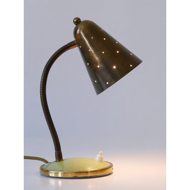 Rare and elegant mid-century modern goos neck desk light or table lamp with perforated conical brass lamp shade. Designed...