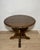 Elegant round side table crafted in richly figured walnut, featuring a sculptural pedestal base with flowing scroll...