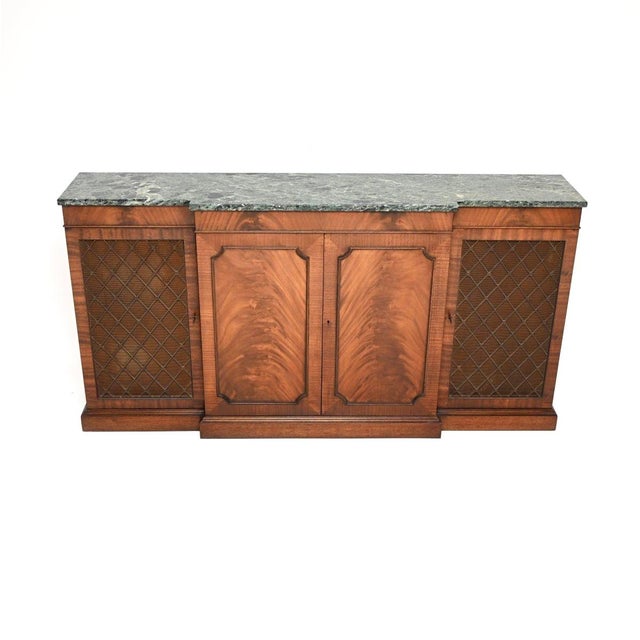 An impressive and very well made antique marble top grill front sideboard in the classic Georgian style. This was made in...