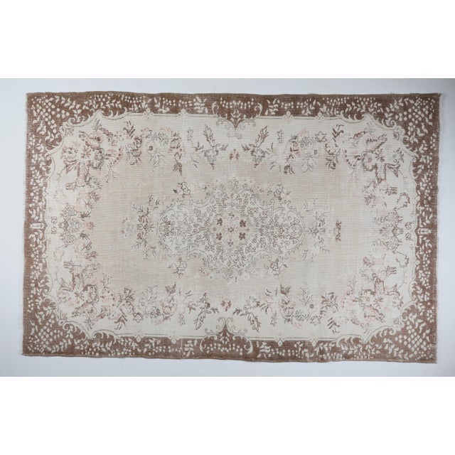 Celebrate the artistry of Anatolian weaving with this elegant Turkish hand knotted vintage rug, a timeless floor piece...