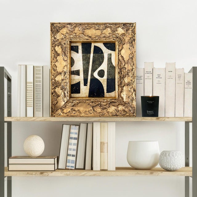 This is a bold paper collage in black and white set in a vintage ornate gold frame. The collage is made from painted paper...