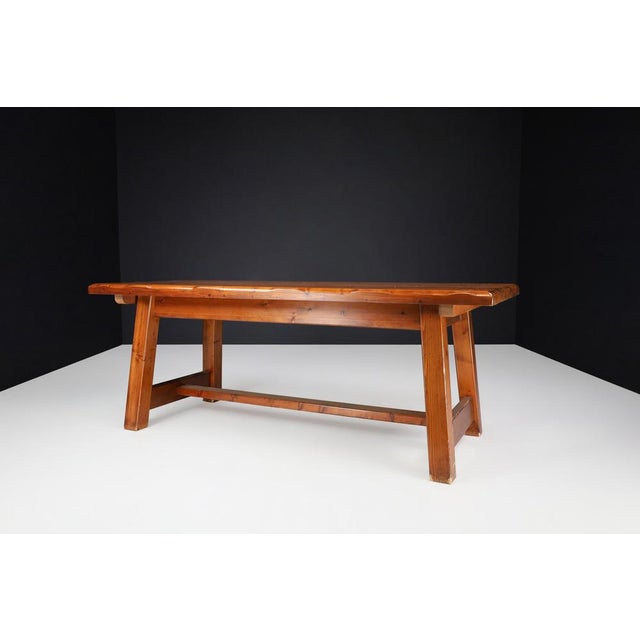 Mid-Century French Solid Pine Dining Table, 1970s This robust and characterful dining table was crafted in France during...