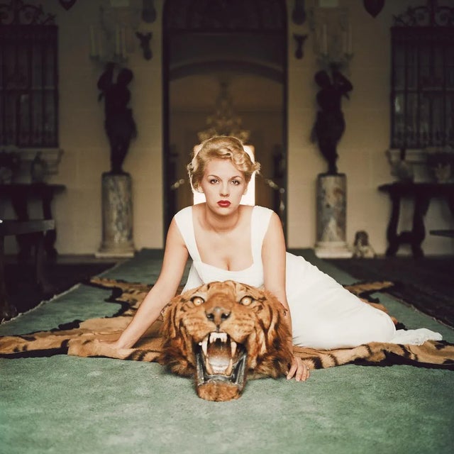 Beauty and the Beast 1959 1959. Lady Daphne Cameron (Mrs George Cameron) on a tiger skin rug in the trophy room at...