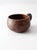 A vintage handmade studio pottery mug with a rounded, low form and a softly pulled handle. The surface is finished in a...