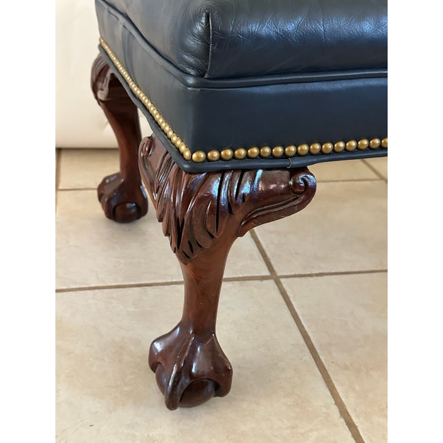Bring timeless elegance to your home with this beautiful vintage leather ottoman upholstered in a rich slate blue leather....