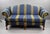A handsome matched pair of upholstered sofas, featuring a timeless blue and gold striped damask fabric. Each sofa...