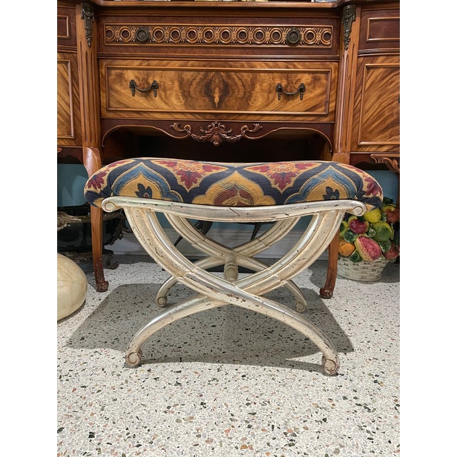 Elegant Italian vintage stool crafted from carved wood and finished in a beautifully aged water-gilded silver. The...