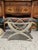 Elegant Italian vintage stool crafted from carved wood and finished in a beautifully aged water-gilded silver. The...