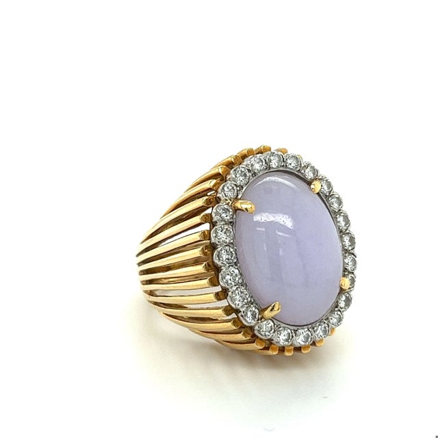 Experience the timeless sophistication of this stunning lavender jade ring. The oval shape cabochon cut jade has been...