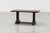 A handsome French coffee table from around 1915, crafted in solid dark oak with a rich, aged patina. The design features a...