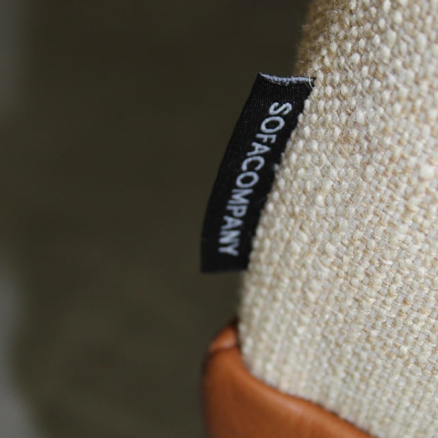 This large daybed has a cream off white wool-cotton blend upholstery. White seat with leather trim and metal legs, back...