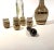 Stunning vintage Bohemian lidded carafe and five shot glass set with 22k gold bands on black and amber glass. So chic!...