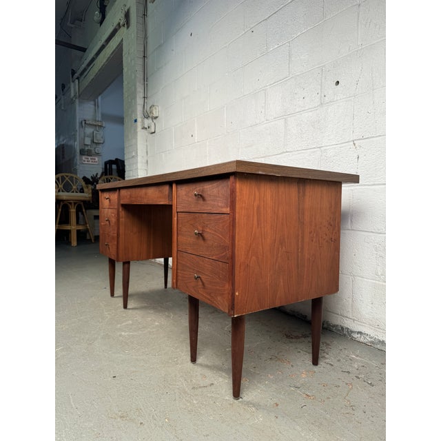 Add a touch of vintage charm to your workspace with this mid-century faux wood laminate desk, a perfect blend of retro...