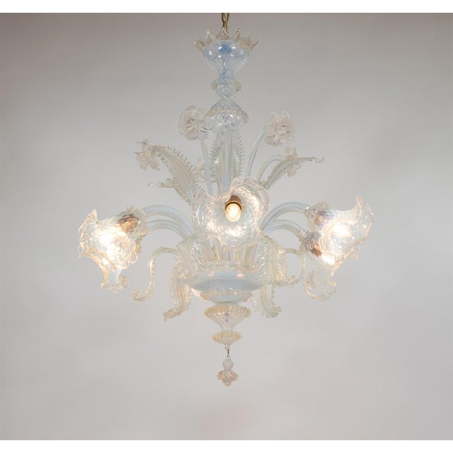 This exquisitely handcrafted gold-infused opaline Murano chandelier features six arms extending from the central bowl. The...