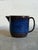 This vintage ceramic pitcher features a stout, cylindrical silhouette defined by a short, wide pouring spout and an...