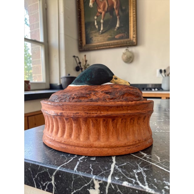 A sculptural French game terrine by Pillivuyt, produced for Lamalle NYC, featuring a resting mallard drake atop a richly...