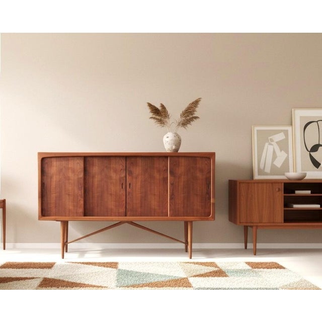 A magical danish cabinet with sliding doors and drawers in teak and walnut ✨ the cabinet has four sliding doors that slide...