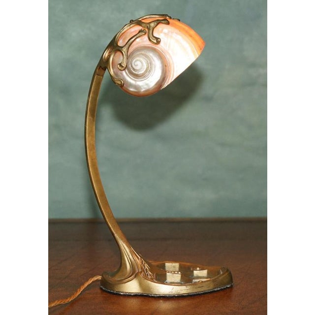 French Art Nouveau table lamp, circa 1900, attributed to Louis Majorelle, with a wonderfully sculptural brass frame and...
